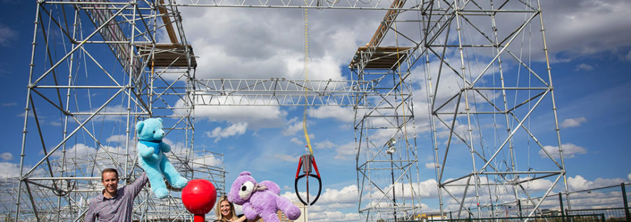 An image of scaffolding setup like a kids claw game with teddy bears.